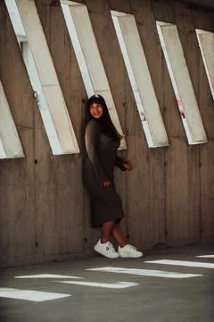 A confident and stylish plus-size woman posing by Stock Photos