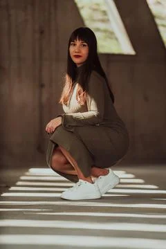 A confident and stylish plus-size woman posing by Stock Photos
