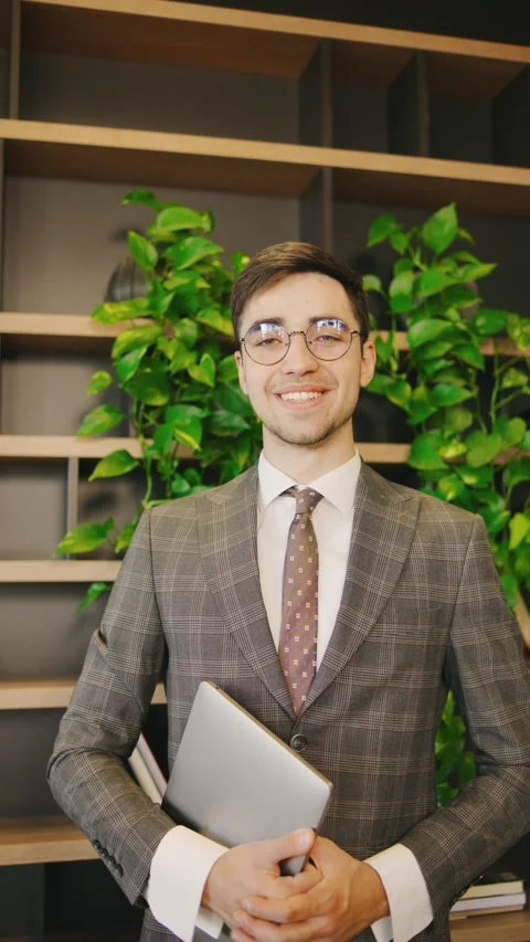 A confident and stylish young professional businessman is smiling brightly while Stock Footage 285683027