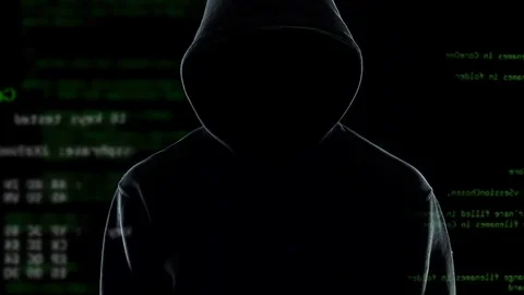 Confident anonymous watching his hacker program cracking passwords and firewalls Stock Footage 85170342