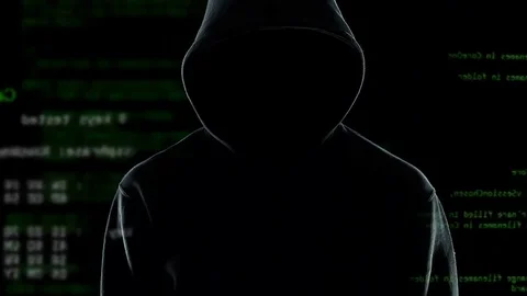 Confident anonymous watching his hacker program cracking passwords and firewalls Stock Footage 85175201