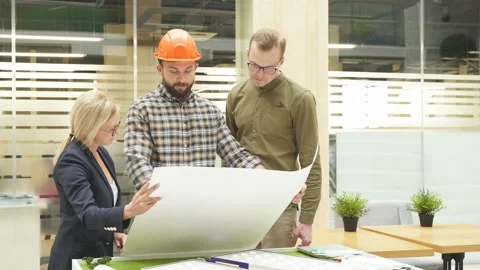 Confident architect man show plan for building to leading engineers. Video stock 146983737