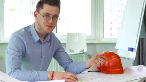 Confident architect smiles while working at his desk Stock-Footage 311989903