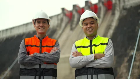 Confident asian two engineers man with safety helmet in construction site dam. Stock-Footage 247107395