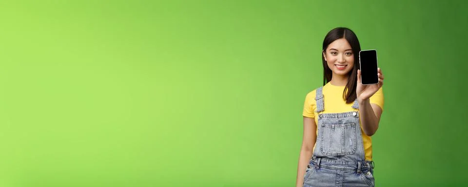 Confident assertive good-looking female asian introduce smartphone app, extend Stock Photos