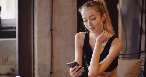 Confident Athlete Using Mobile Phone At Gym Stock-Footage 136674039