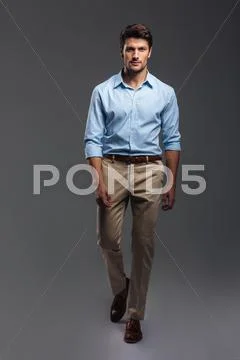 Confident attractive young manwalking and looking camera Stock Photos