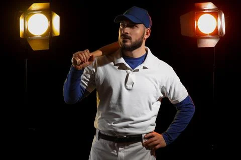 Confident baseball player with bat on shoulder, studio lighting, sports and a Stock Photos