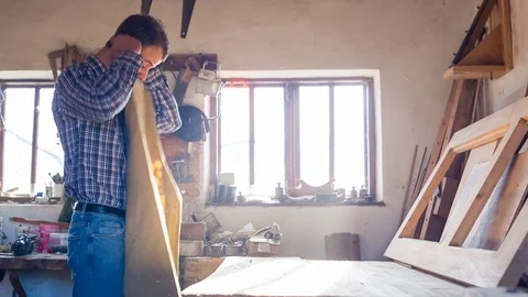 Confident bearded carpenter stood in the studio and took an apron Stock Footage 84334099
