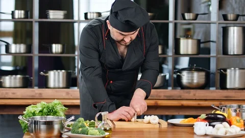 Confident bearded chef prepare meal at cuisine. Shot with RED camera in 4K Stock Footage 124157557