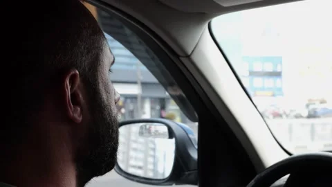 Confident bearded man looking concentrated to urban road while riding electric a Stock Footage 345264061