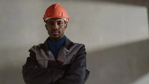 Confident Black Engineer Wearing Hard Hat Posing At Worksite Stock Footage 320669817