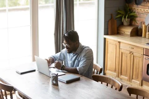 Confident black guy hold virtual business meeting online using laptop Stock Photos