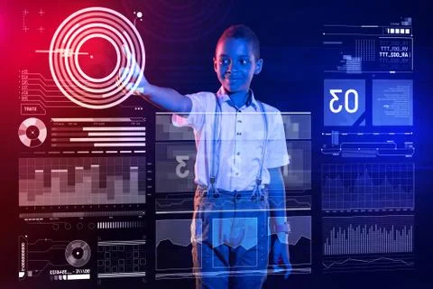 Confident boy smiling while using a futuristic device at home Foto stock