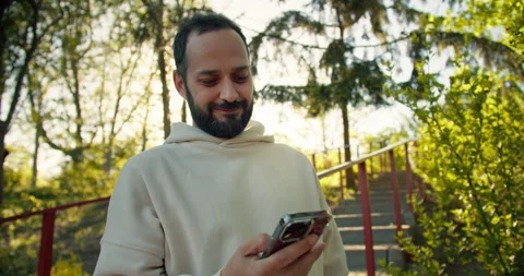 Confident brunette guy with a beard communicates using social networks in a Stock Footage 280632891