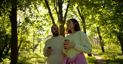 A confident brunette guy with a beard in a white hoodie and his brunette Stock Footage 280616209
