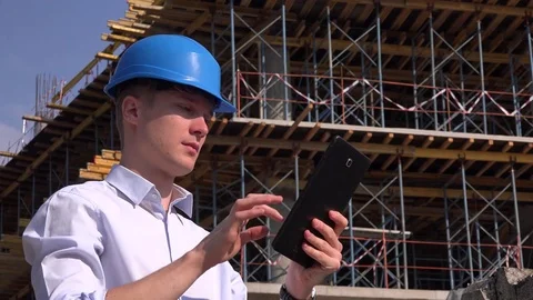 Confident builder contractor sliding tablet touchscreen smiling joyful portrait Stock Footage 79632507