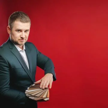 Confident business leader or manager standing in the studio with samples of Stock Photos
