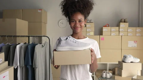 Confident business owner looking at camera in delivery shipping warehouse. Видео 231971807