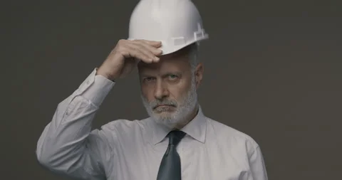 Confident businessman and engineer posing with a safety helmet Stock Footage 140402902