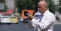 Confident Businessman Browse Internet Web Pages Using Touch Tablet City View 4k or 4k+ Resolution
