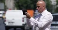 Confident Businessman Browse Internet Web Pages Using Touch Tablet City View 4k or 4k+ Resolution