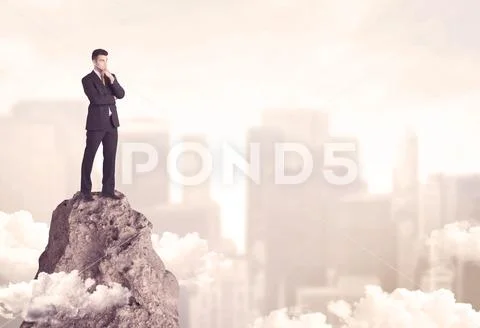 Confident businessman on dangerous cliff Stock Photos