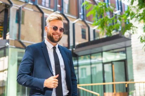 Confident businessman in front of modern office building. Financial investor is Stock Photos