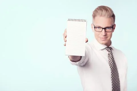 Confident businessman presenting empty notebook. Stock Photos