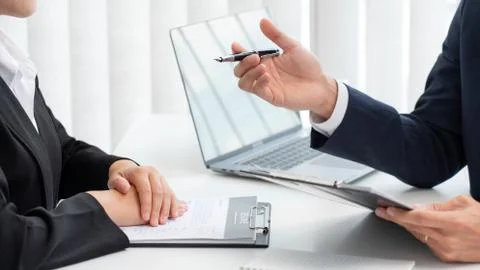 Confident businessman sitting in front of office manager talk conducting to i Stock Photos