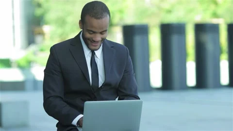 Confident businessman smiling while working on a laptop Stock Footage 311827091