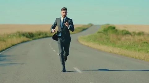 Confident businessman use smartphone throws the phone takes off his jacket runs Stock Footage 135978291