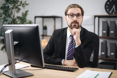 Confident businessman using computer at work Stock Photos