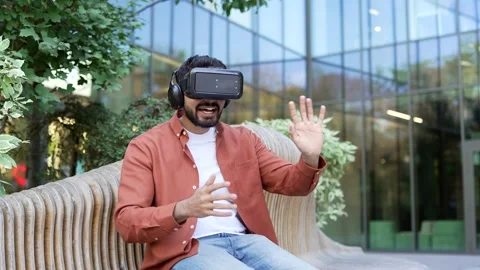 Confident businessman using VR glasses for video call and chatting online  Stock Footage 304588705