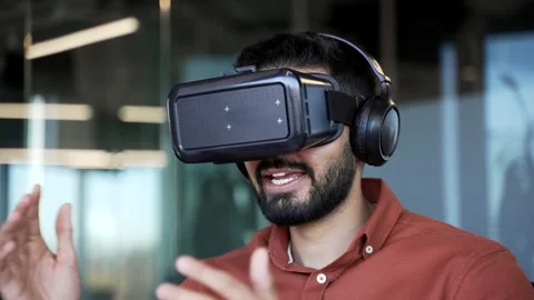 Confident businessman using VR glasses for video call and online chat in virtual Stock Footage 305657600