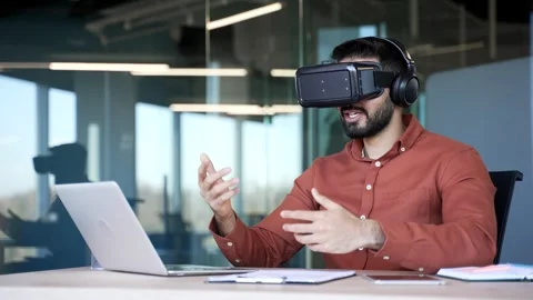 Confident businessman using VR glasses for video call and online chat in virtual Stock Footage 320618136