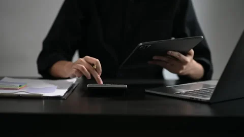 Confident businessman working on laptop,tablet and smartphone at her workpl.. Stock Footage 252183107