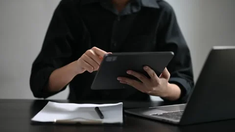 Confident businessman working on laptop,tablet and smartphone at her workpl.. Stock Footage 252183110