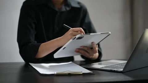 Confident businessman working on laptop,tablet and smartphone at her workpl.. Stock Footage 252183115