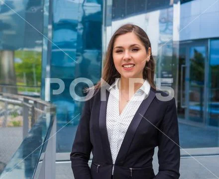 Confident businesswoman in front of modern office building. Business, banking Stock Photos