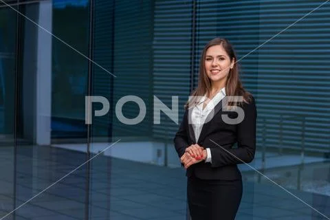 Confident businesswoman in front of modern office building. Business, banking Stock Photos