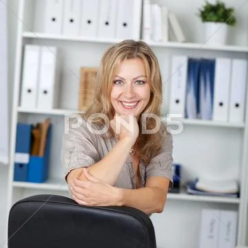 Confident businesswoman with hand on chin Stock Photos