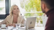 Confident Businesswoman Talking To Young Colleagues At Business Meeting Stock Footage