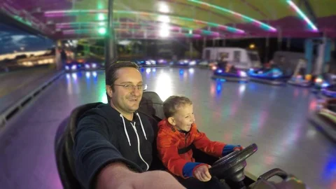 Confident child is driving  at roller coaster, father have fun with son  Video stock 93264686