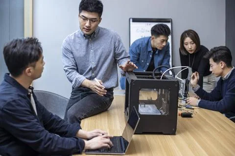  Confident Chinese designers using a 3D printer Beijing China Copyright: x... Foto stock