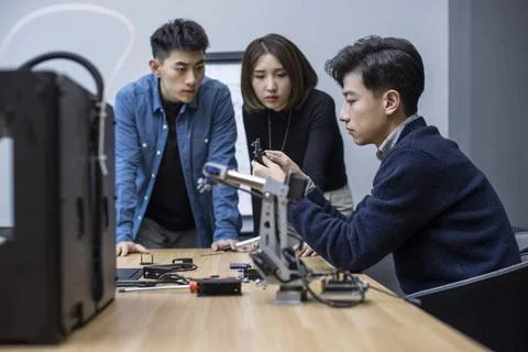  Confident Chinese designers using a 3D printer Beijing China Copyright: x... Foto stock
