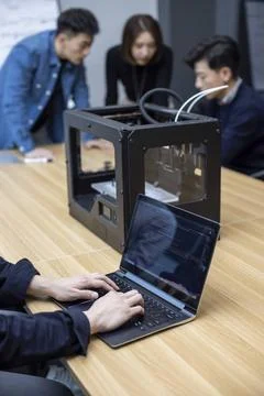  Confident Chinese designers using a 3D printer Beijing China Copyright: x... Foto stock