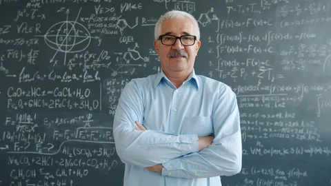 Confident college teacher standing in class with arms crossed looking at camera Stock Footage 124868443