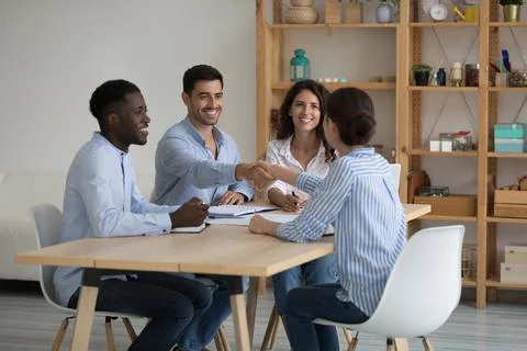 Confident company HR team and new hired employee shaking hands Stock Photos