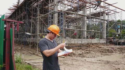 Confident construction engineer checking work at construction site. Stock-Footage 117330149